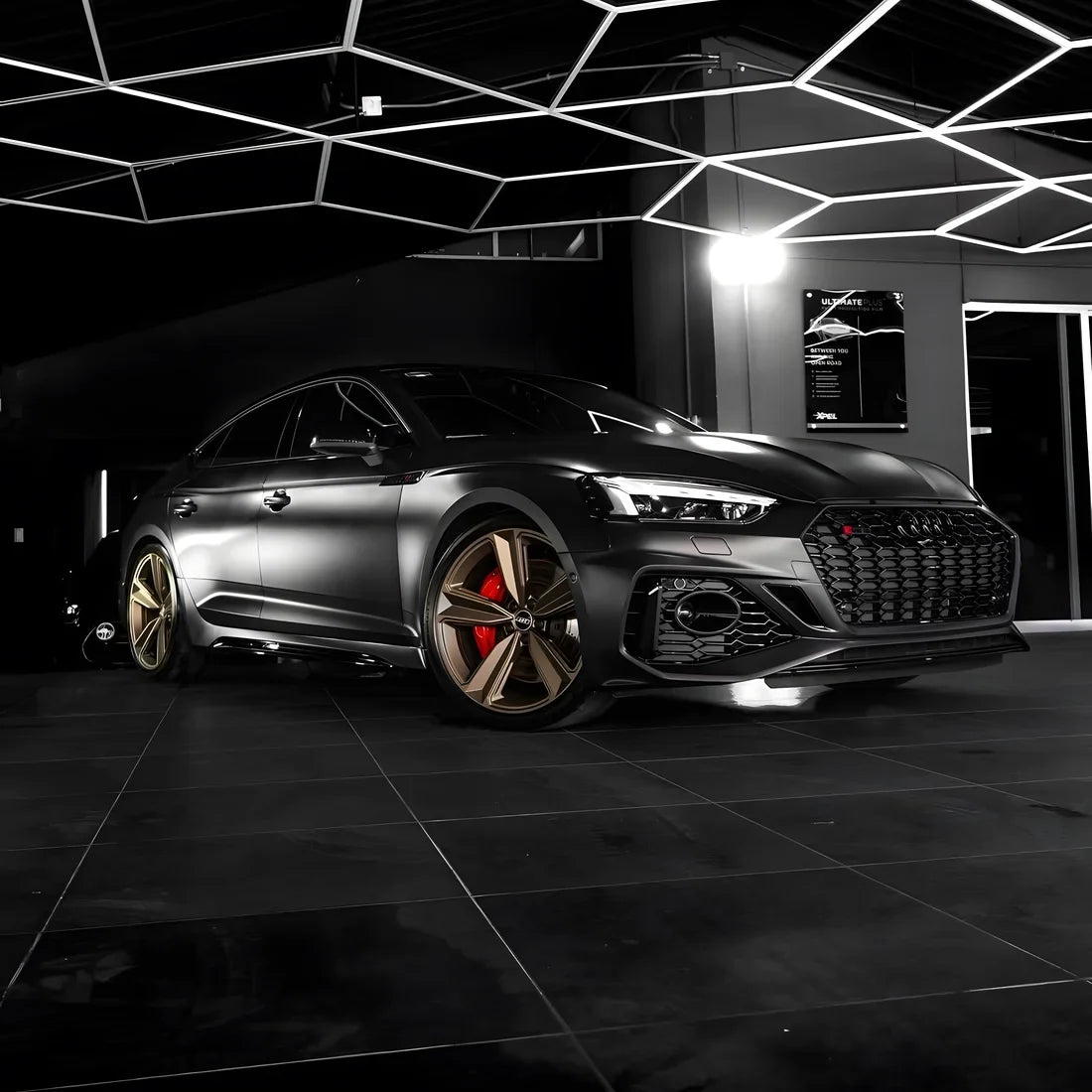 A satin matte black vinyl wrap on luxury sedan