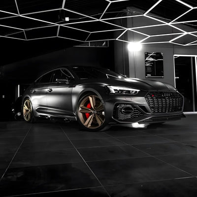 A satin matte black vinyl wrap on luxury sedan