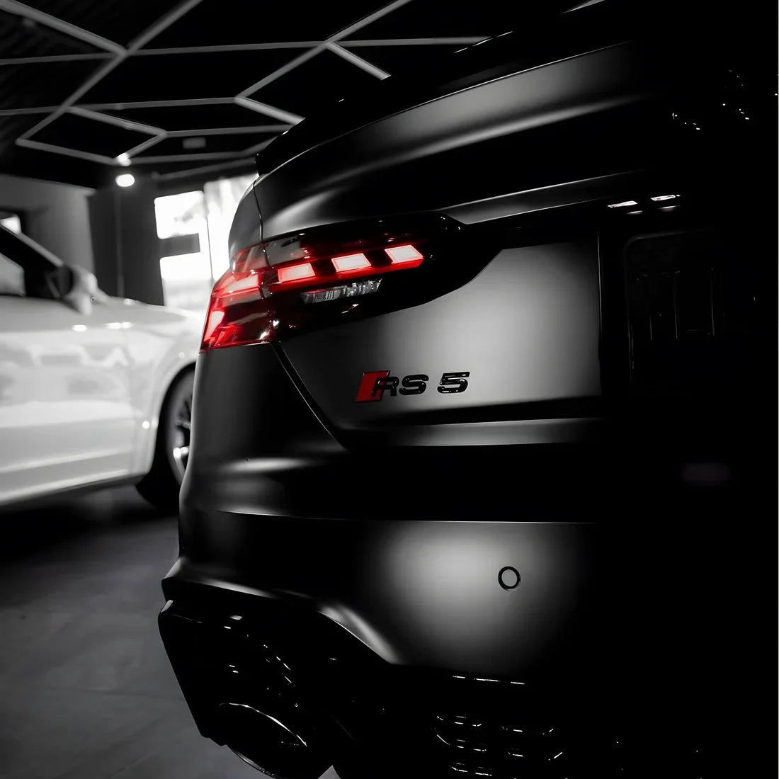 Close-up rear view of a matte black BMW RS 5 M series