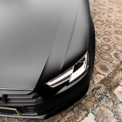 Close-up of Matte Black Vinyl Wrap on Audi headlight