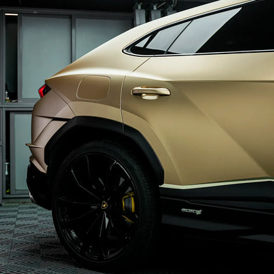Satin Metallic Imperial Gold vinyl wrap on Lamborghini Urus panel