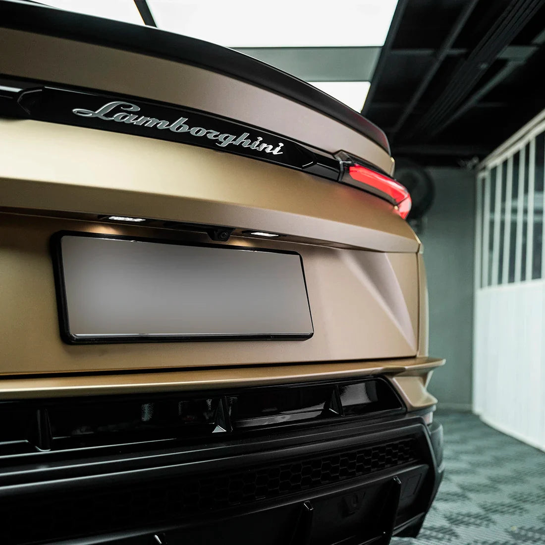 Satin Metallic Imperial Gold vinyl wrap on Lamborghini Urus rear bumper