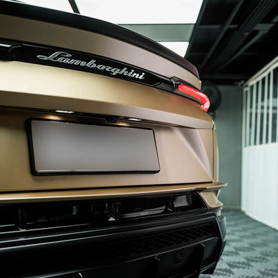Satin Metallic Imperial Gold vinyl wrap on Lamborghini Urus rear bumper