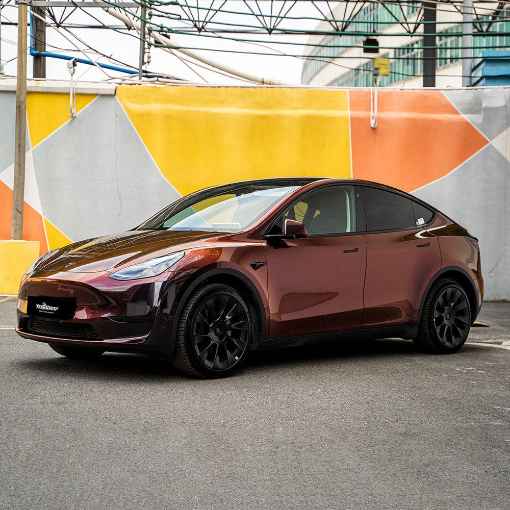 Side view of Tesla SUV wrapped with Madeira Red (RD17-HD) Chameleon Metallic Vinyl Wrap, capturing its sophisticated color shift from deep wine-red to glowing metallic burgundy.