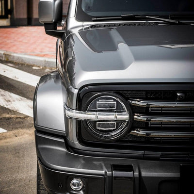 Detailed close-up of the Tank SUV’s headlight and front fender wrapped in TeckWrap’s premium gloss vinyl.