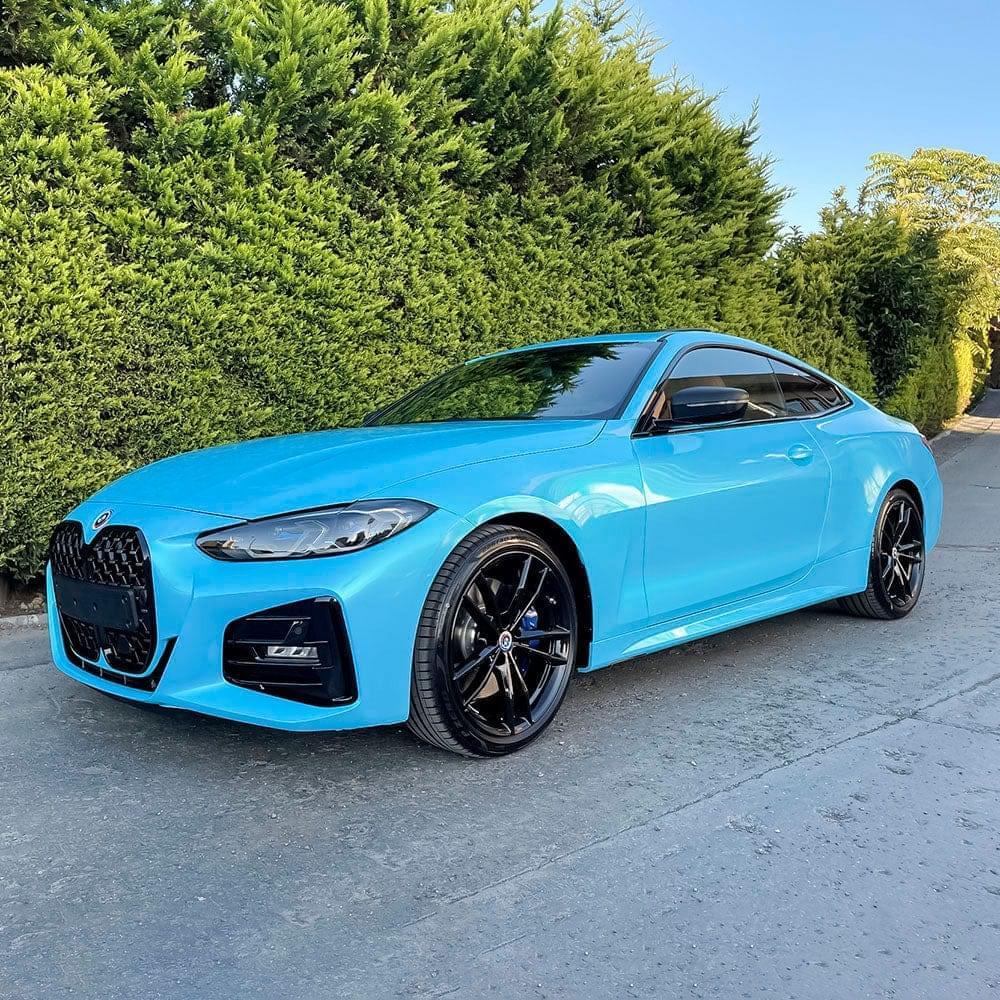 BMW 4 Series Coupe finished in a vibrant custom light blue or turquoise vinyl wrap