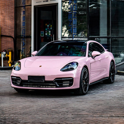 Porsche wrapped in TeckWrap Millennial Pink Gloss Vinyl, demonstrating a sophisticated, sleek appearance with a vibrant pastel pink finish.