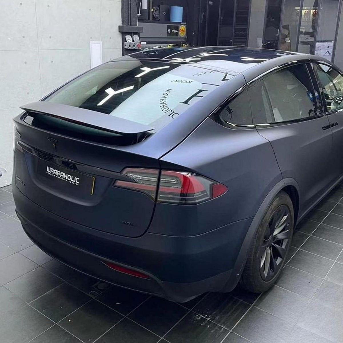 of Tesla car wrapped in premium TeckWrap Satin Boysenberry Black  vinyl