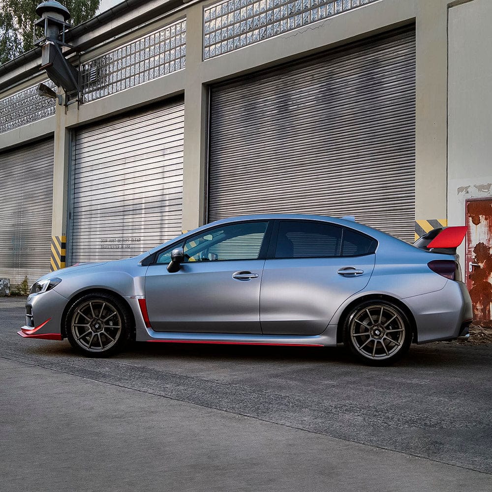 Side view of a Subaru sedan wrapped in Gunmetal Grey satin vinyl
