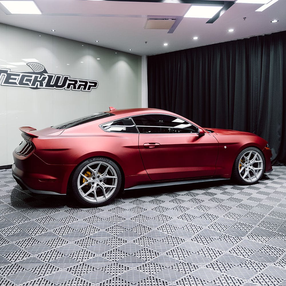 Side profile of a Ford Mustang in TeckWrap Satin Metallic Oxide Red (SMT18) vinyl wrap, highlighting the smooth matte texture and metallic shine.